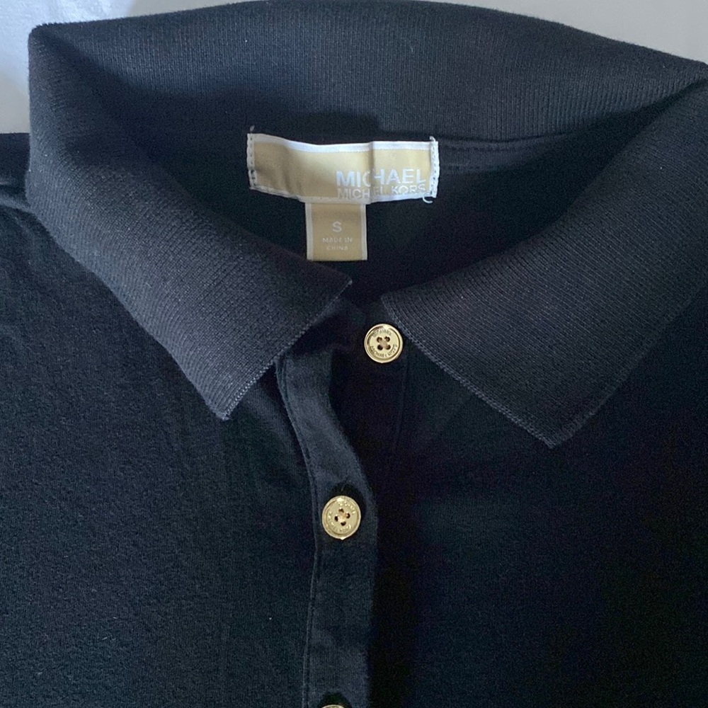 Size S. Black polo shirt.